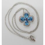 A Mappin & Webb 18ct white gold blue topaz tanzanite and diamond flower pendant and chain, pendant