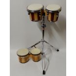 A set of bongo drums with stand and another set by El Cometa Condition Report: Available upon