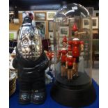 A Firetrap grey and silver "Deadly" the gnome together with three wooden figures of Pinocchio