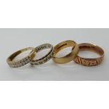 A 9ct rose gold engraved wedding band, size T, a 9ct plain wedding ring size N1/2 and two 9ct gem