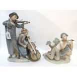 A large Nao figure of a boy playing a violin and a girl playing a cello together with a Lladro