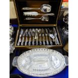 A lot comprising a cased twenty four piece EP fish cutlery set with servers and a sweet meat dish (