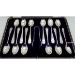 A cased set of eleven silver spoons with tongs, Sheffield 1916, with an odd EPNS spoon Condition