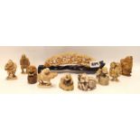 An ivory bridge carved with a village and assorted netsukes Condition Report: Available upon