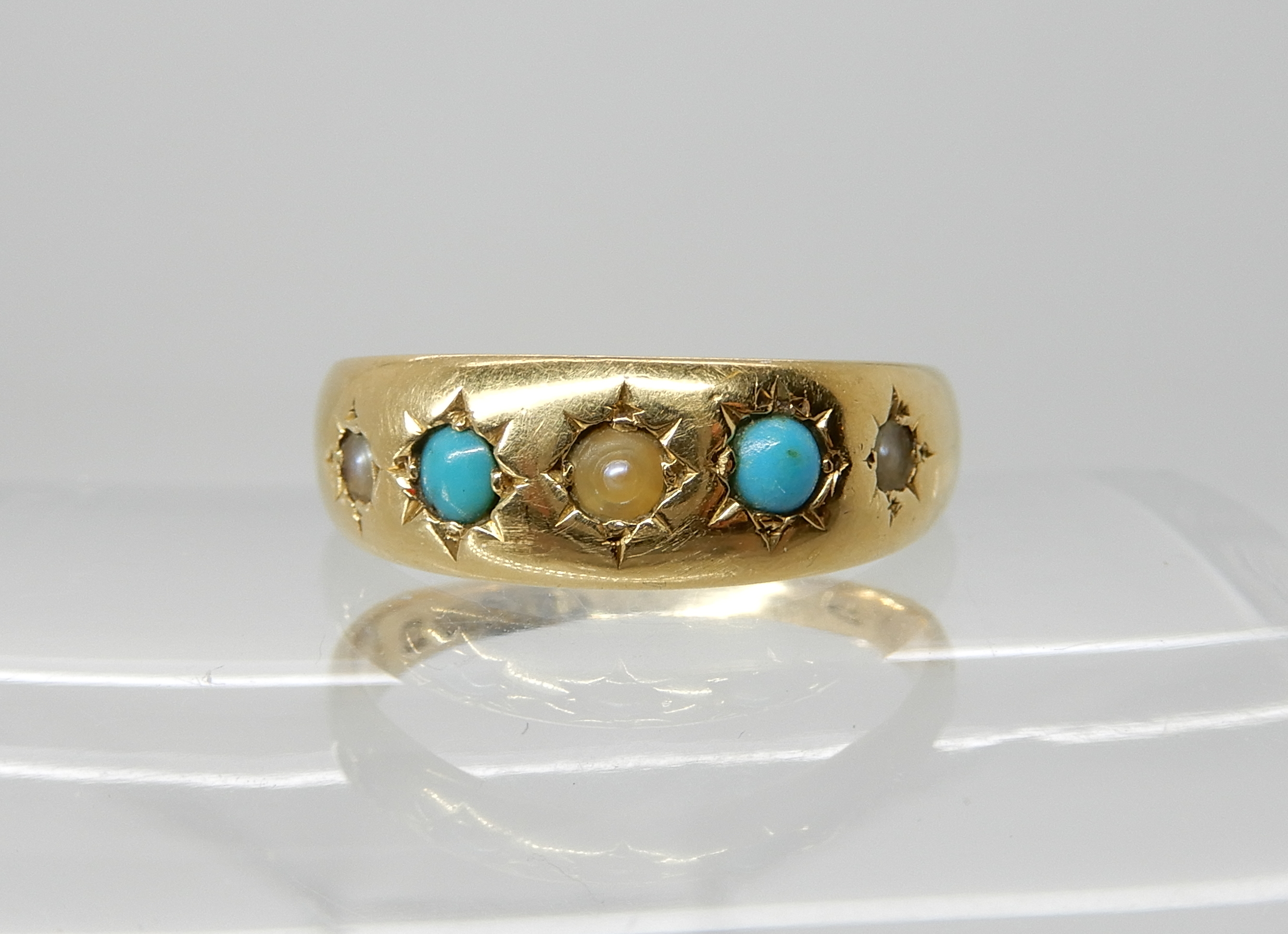 An 18ct gold turquoise and pearl ring, dated Chester 1897, size P1/2, weight 3.6gms Condition