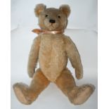 A large 20th Century Teddy bear with stitched muzzle, claws and paws, 70cm long Condition Report: