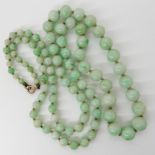 A string of Chinese green hardstone beads, length 68cm Condition Report: Available upon request
