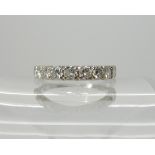 An 18ct white gold diamond set half eternity ring, set with estimated approx 0.90cts, size O, weight