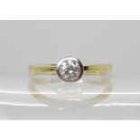 An 18ct yellow gold diamond solitaire ring with an estimated approx 0.40ct diamond in a white gold