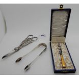 A lot comprising a pair of silver sugar tongs, EP grape scissors and a cased Danish silver and