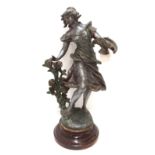 A spelter figure of a woman picking flowers Condition Report: Available upon request