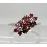 A 14k white gold ruby and diamond twin flower ring, size P, weight 2.8gms Condition Report: