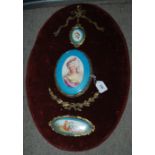 An oval panel with three porcelain plaques Condition Report: Available upon request
