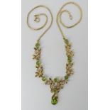 A 9ct gold and peridot floral pendant necklace, length 44cm, middle part of the pendant 3.5gms,