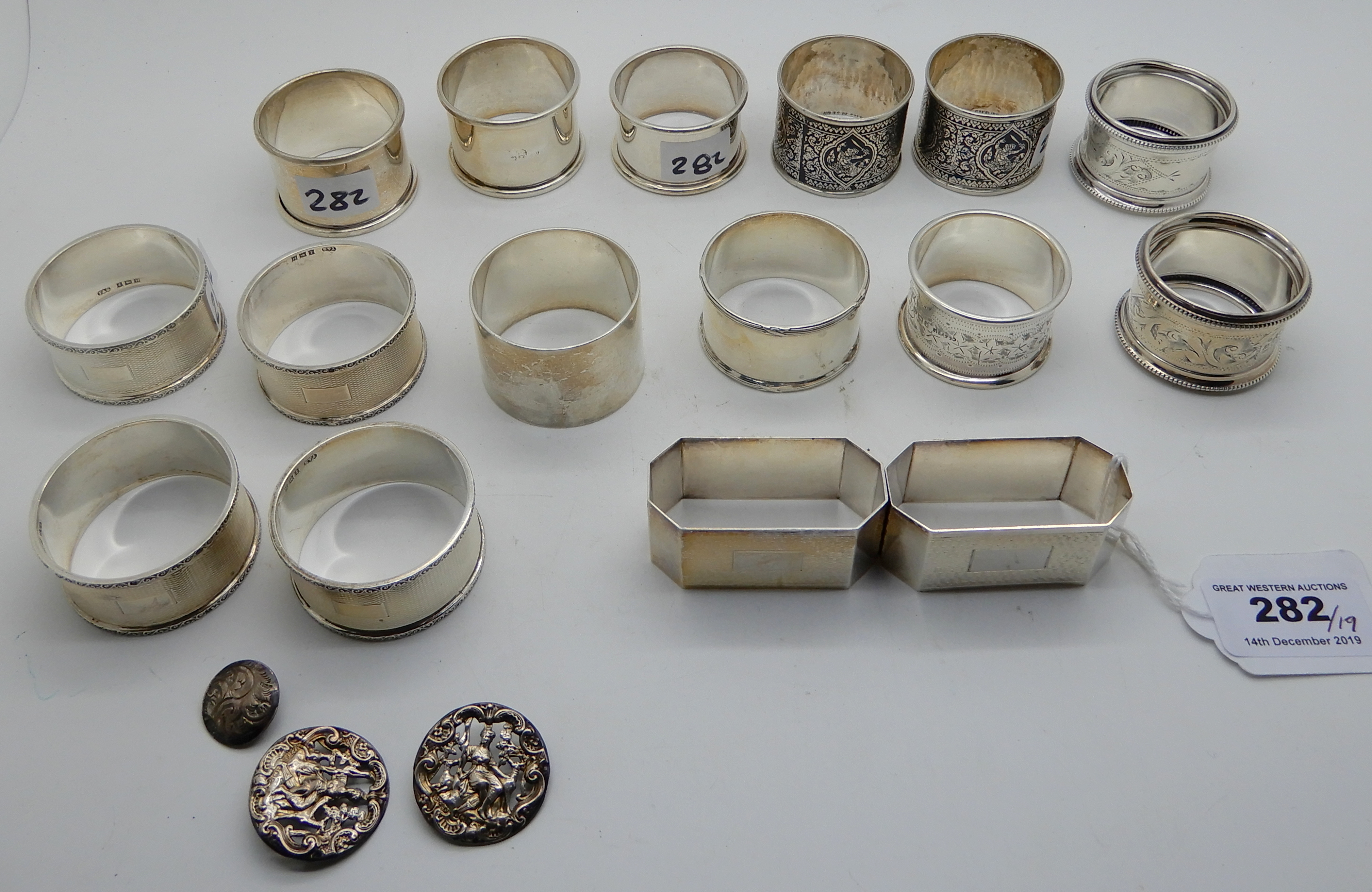 A lot comprising a pair of silver napkin rings, Birmingham 1947, twelve other silver napkin rings (