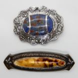 A white metal Arts & Crafts brooch stamped with the makers mark HWK, with an enamelled plaque,