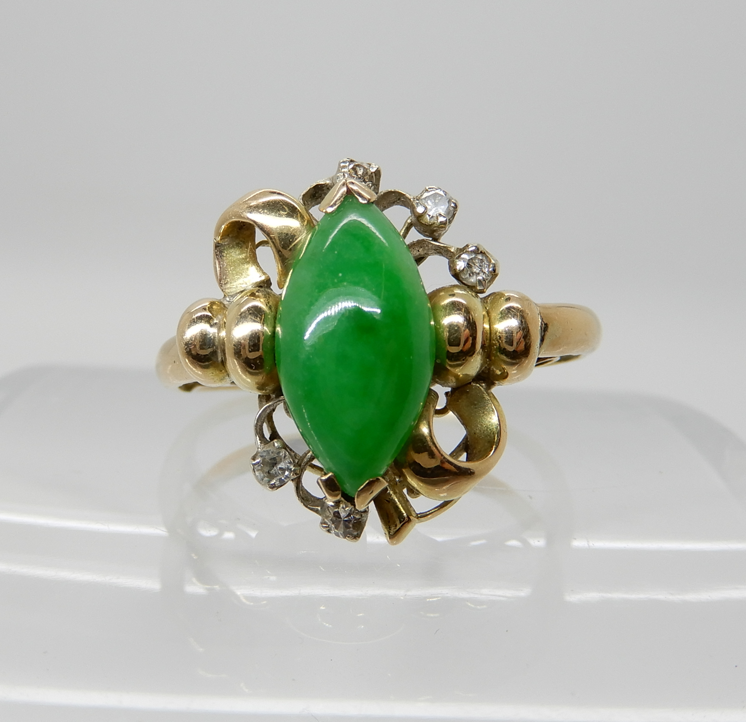 A bright yellow metal Chinese green hardstone and diamond accent ring, size S, weight 4gms Condition