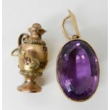 A three colour yellow metal ewer charm length 2.7cm, together with a yellow metal mounted amethyst