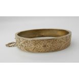 A yellow metal engraved bangle, weight 14.3gms Condition Report: Available upon request