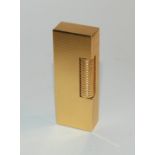 A yellow-metal Dunhill lighter Condition Report: Available upon request