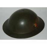 A military helmet and various rings and military badges Condition Report: Available upon request