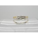 An 18ct gold and platinum three stone diamond ring set with estimated approx 0.35cts of brilliant