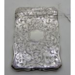 A silver card case by Nathaniel Mills, Birmingham 1872, of rectangular form with foliate decoration,