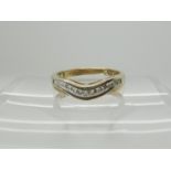 A 9ct gold diamond set wave eternity ring, set with estimated approx 0.15cts of brilliant cut