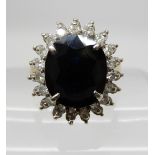 An 18ct gold large sapphire and diamond cluster ring, sapphire approx 11.7mm x 10mm x 5.1mm and