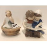 A Bing and Grondhal figure group of children reading and a Royal Copenhagen figure of a girl in a