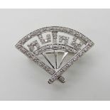 A fan shaped diamond set brooch stamped 14k, dimensions 2.4cm x 1.8cm, weight 2.7gms Condition