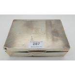 A presentation silver cigarette box, Sheffield 1923, the hinged cover monogrammed "JLO" and the