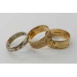 Two 9ct gold wide wedding bands, sizes V1/2, and T, combined weight 7.3gms, together with a 9ct