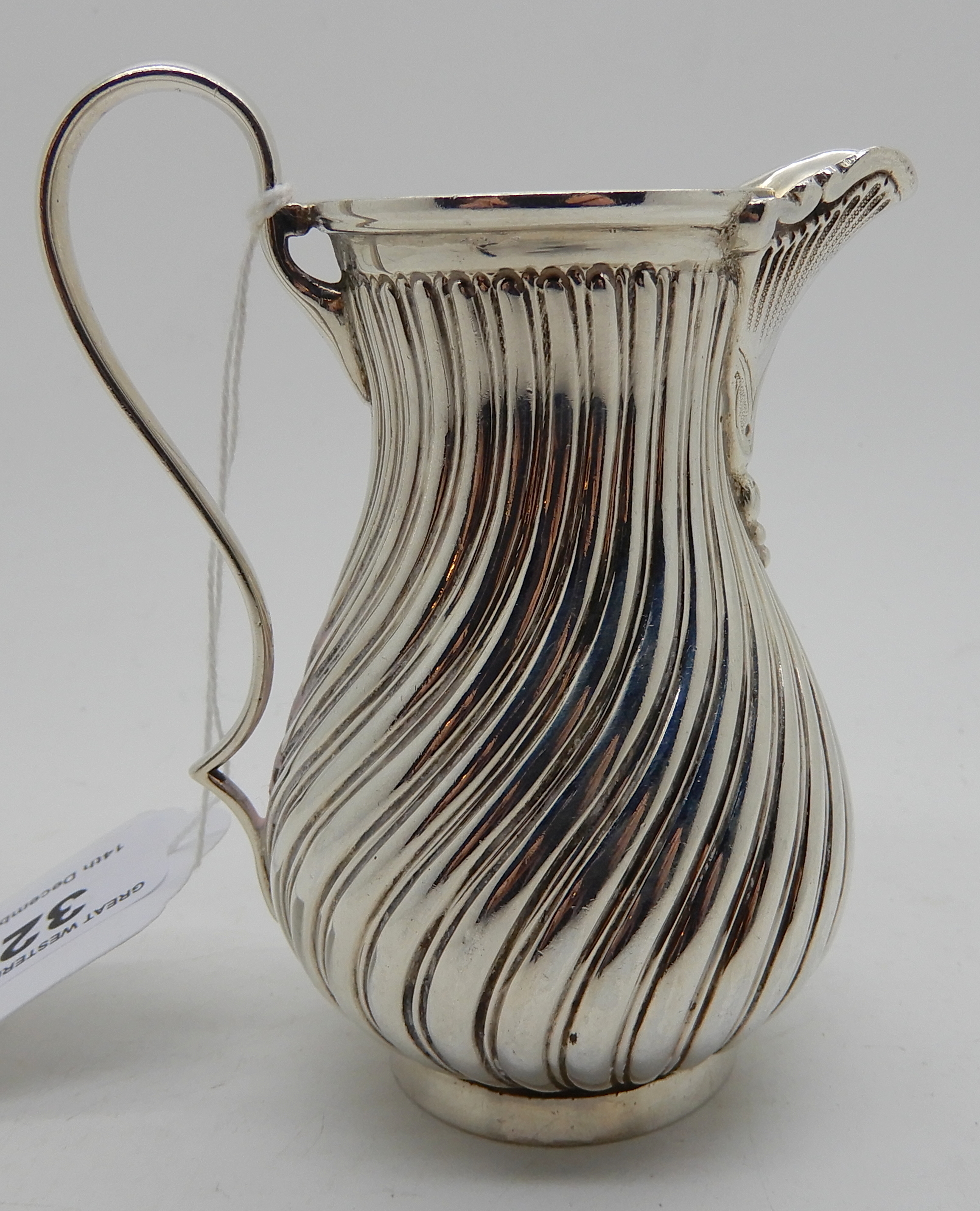 A silver cream jug by James Dixon & Sons, Sheffield 1887, of baluster shape with spiral fluting, 9cm - Image 2 of 4