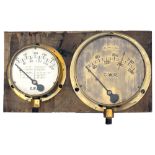 A pair of GWR brass cased locomotive gauges mounted on a board. One is a loco boiler pressure gauge,