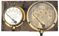 A pair of GWR brass cased locomotive gauges mounted on a board. One is a loco boiler pressure gauge,