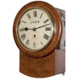 North Eastern Railway 8 inch oak cased drop dial clock with a wire driven movement. Original dial