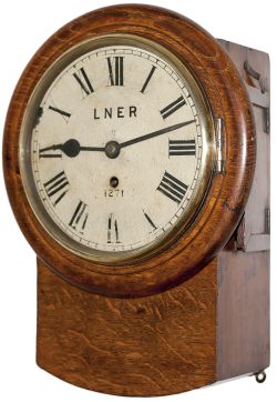 North Eastern Railway 8 inch oak cased drop dial clock with a wire driven movement. Original dial