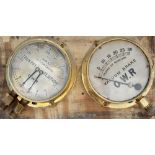 A pair of GWR brass cased locomotive gauges mounted on a board. One is a loco vacuum Brake gauge,