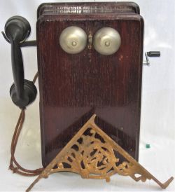 Control Telephone with bakelite handset together with a domestic cast iron 90 degree wall bracket