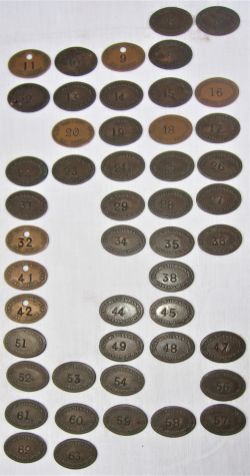 A collection of 48 GWR oval LOCO DEPT pay checks numbered 1 to 63 with missing numbers. Recovered