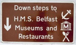 Road Sign. DOWN STEPS TO HMS BELFAST MUSEUMS AND RESTAURANTS. A famous London landmark of the