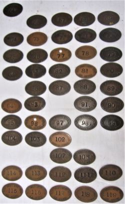 A collection of 48 GWR oval LOCO DEPT pay checks numbered 64 to 119 with missing numbers.