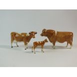 A Beswick family group of three Guernsey cattle