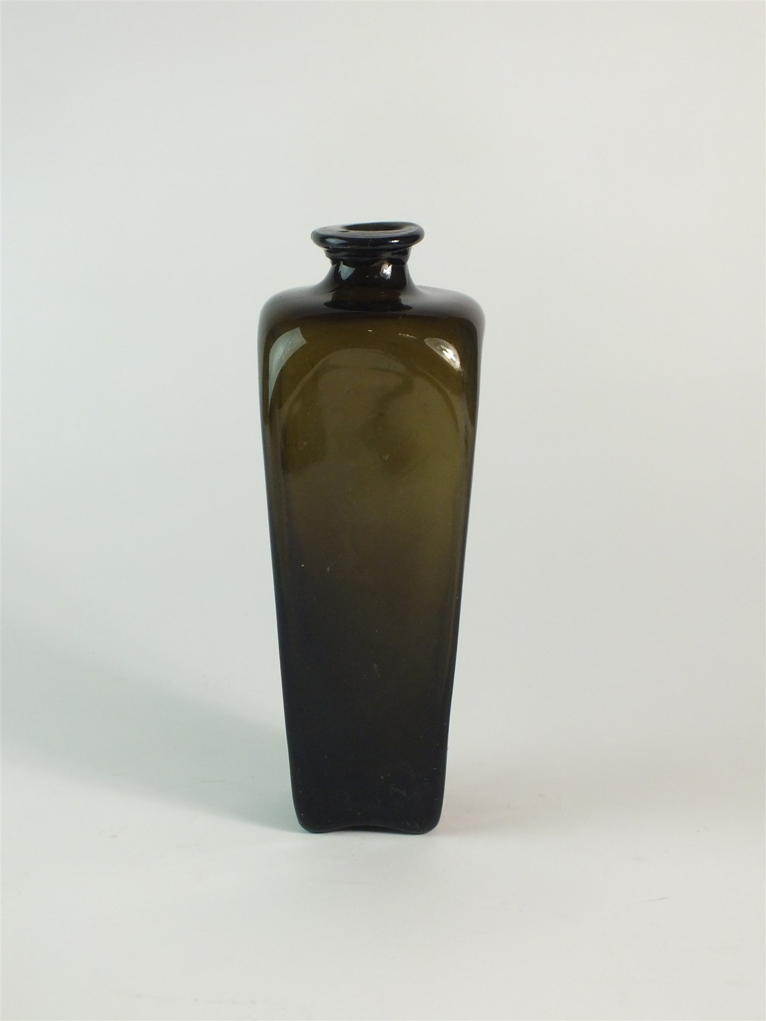 An 18th century green glass gin bottle