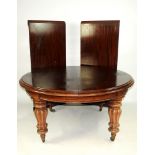 A mid Victorian mahogany pull out action dining table