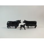 A family group of three Beswick Aberdeen Angus cattle
