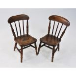 A pair of children's beech framed kitchen chairs