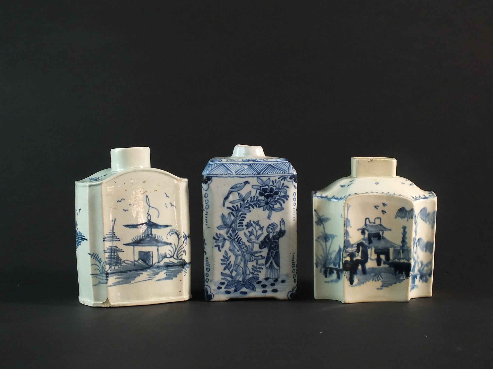 A Dutch delft tea caddy and two English pearlware caddies