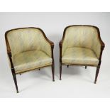 A pair of late French Empire mahogany framed brass-strung bergere tub chairs